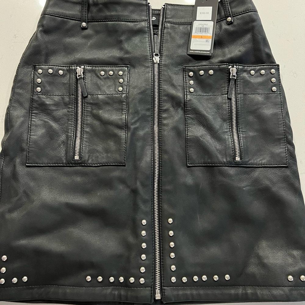 Brand new black leather skirt. Zipper goes all the way down .